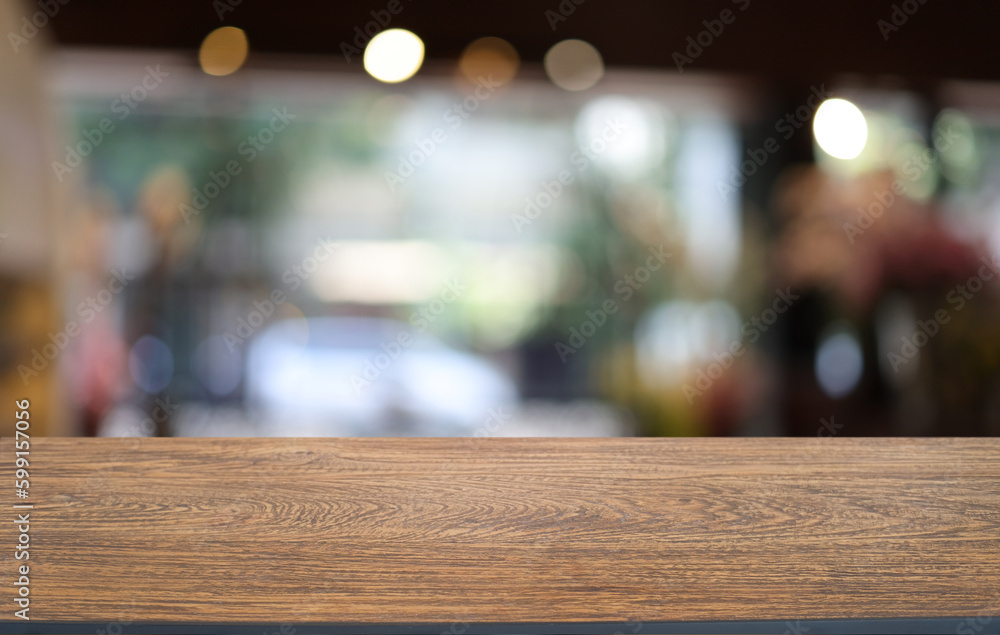 Empty wooden table in front of abstract blurred background of coffee shop . can be used for display or montage your products.Mock up for display of product