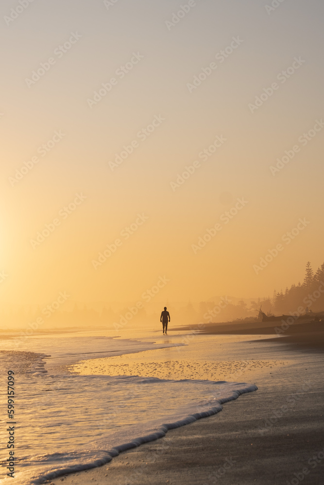 Man walking in to the sunset 