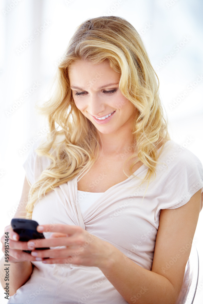 Happy woman, phone and smile for communication, social media or texting while sitting on chair at home. Female person smiling in happiness for chatting, browsing or research on mobile smartphone app Happy woman, phone and smile for communication, social media or texting while sitting on chair at home. Female person smiling in happiness for chatting, browsing or research on mobile smartphone app