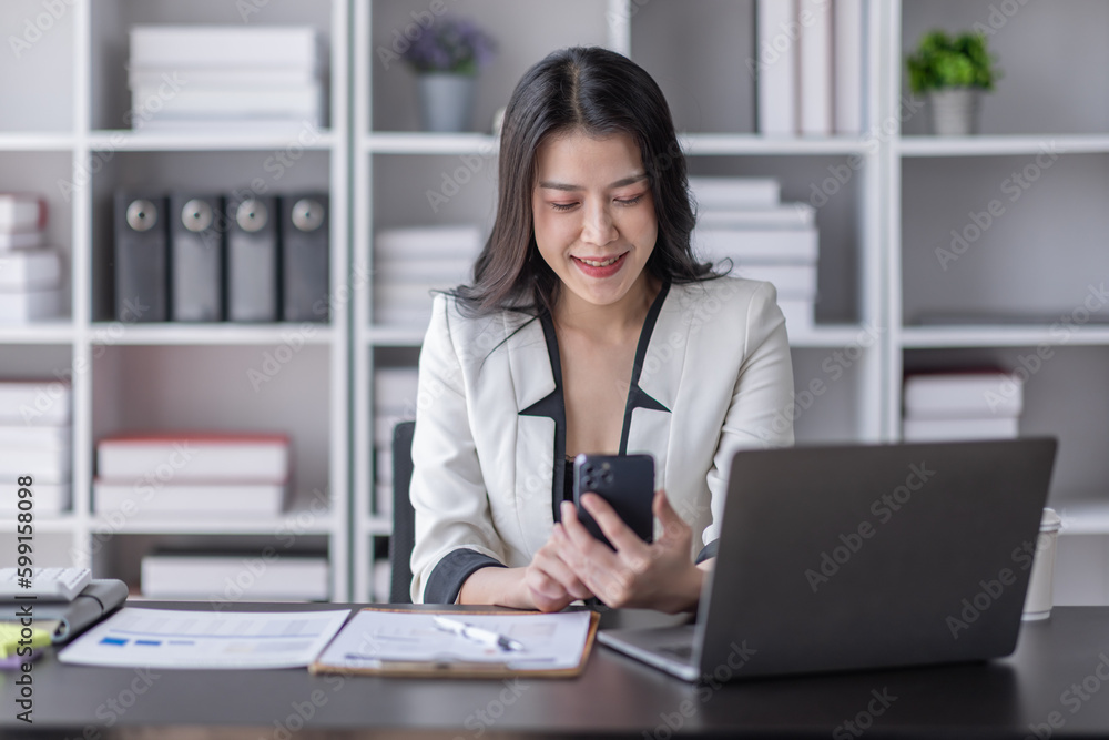Cheerful business Asian woman freelancer making telephone call share good news about project working in office workplace, business finance concept. Cheerful business Asian woman freelancer making telephone call share good news about project working in office workplace, business finance concept.