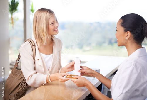 Shopping, happy and a woman with a credit card for a cashier for skincare, service and care of skin. Smile, talking and a female customer speaking to a worker about a product after making a payment