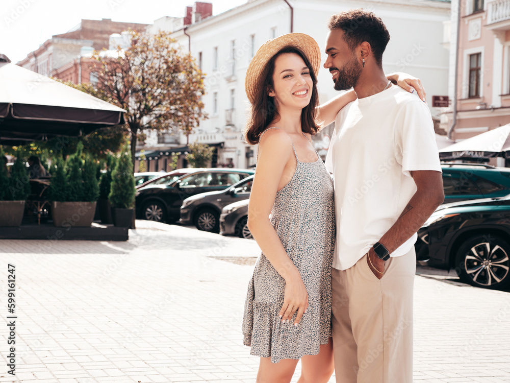Smiling beautiful woman and her handsome boyfriend. Woman in casual summer clothes. Happy cheerful family. Female having fun. Sexy couple posing in the street at sunny day. In hat