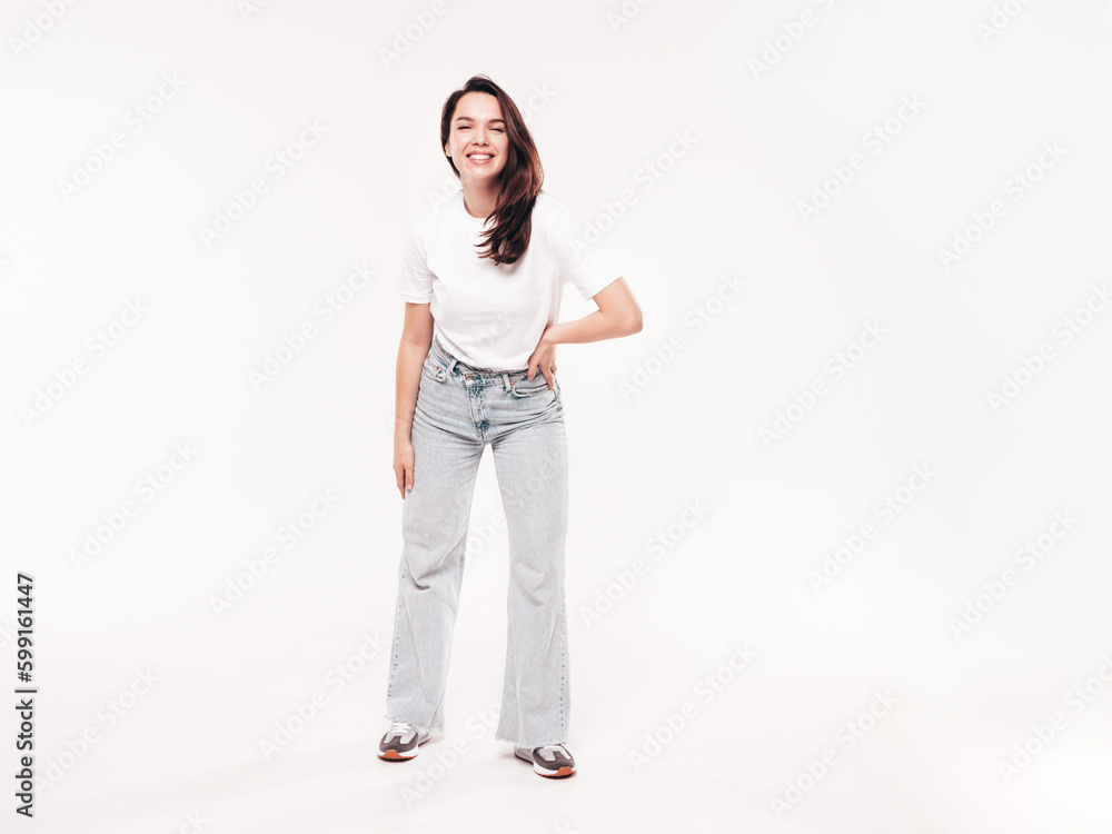 Young beautiful woman. Trendy carefree model in casual summer white T-shirt and blue jeans. Positive female isolated on white in studio. Cheerful and happy. Copy space, mockup. full length Young beautiful woman. Trendy carefree model in casual summer white T-shirt and blue jeans. Positive female isolated on white in studio. Cheerful and happy. Copy space, mockup. full length