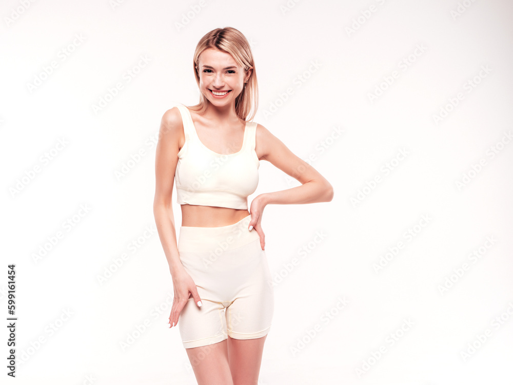 Young beautiful smiling blond female in summer cycling shorts clothes. Sexy carefree woman posing on white background in studio. Positive model having fun indoors. Cheerful and happy. Very slim Young beautiful smiling blond female in summer cycling shorts clothes. Sexy carefree woman posing on white background in studio. Positive model having fun indoors. Cheerful and happy. Very slim