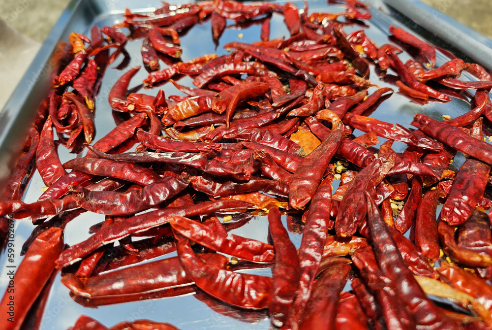 Organic dried chili on stainless steel tray Organic dried chili on stainless steel tray