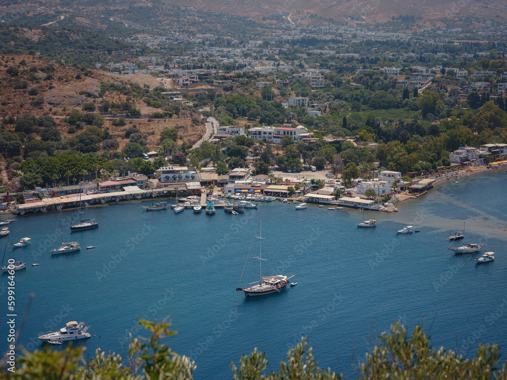 Bodrum summer travel to Turkey. Summer noon sea village Gumusluk Mugla province, bay with clear blue water and boats