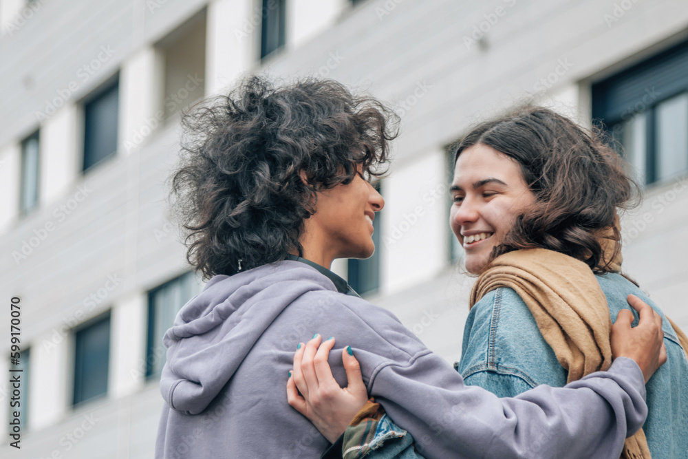 happy teenage couple hugging on the street happy teenage couple hugging on the street