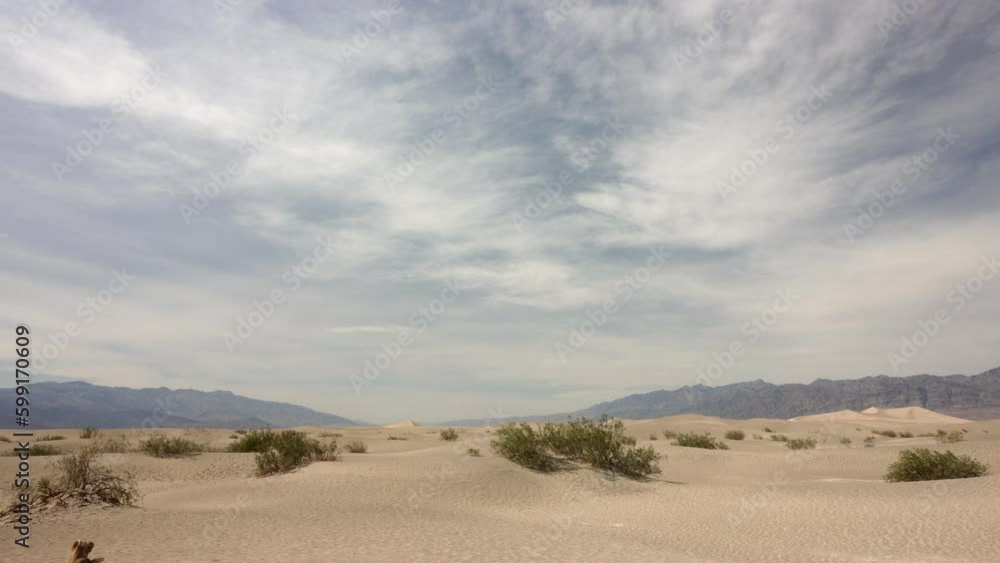 Timelapse of sand dunes in Death Valley USA America with sand and a cloudy sky