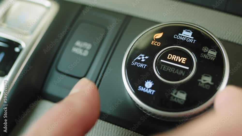 A detail with a sport mode switch in the car. Button for manual