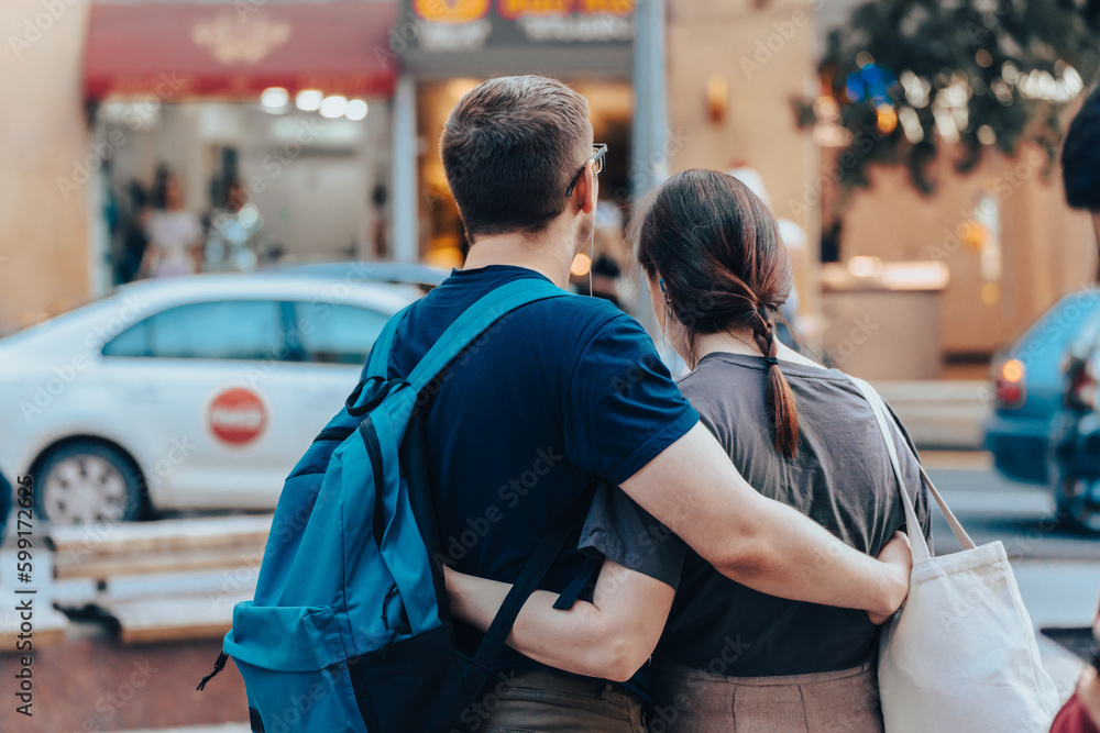 Young couple standing in an embrace in the city