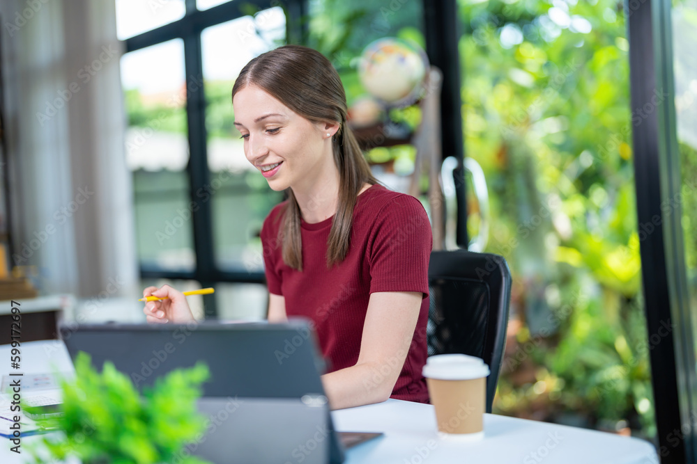 Smiling businesswoman working together on contract document, happy colleague meeting for planning new project in office Smiling businesswoman working together on contract document, happy colleague meeting for planning new project in office