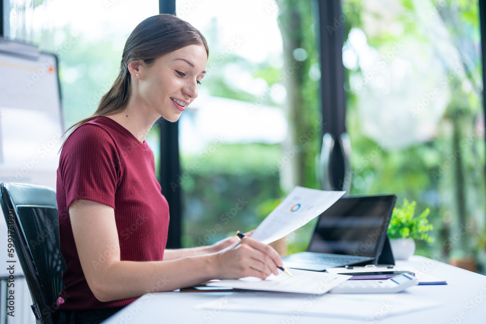 Woman working with laptop at home desk, close-up Woman working with laptop at home desk, close-up