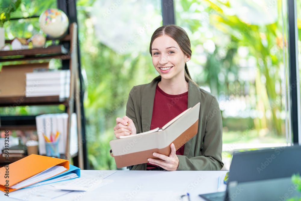 Smiling businesswoman working together on contract document, happy colleague meeting for planning new project in office Smiling businesswoman working together on contract document, happy colleague meeting for planning new project in office
