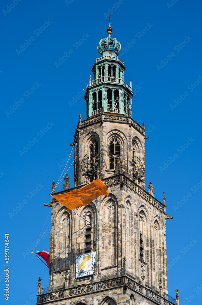The famous Martinitoren in Groningen with orange and Dutch flags during Kingsday.
