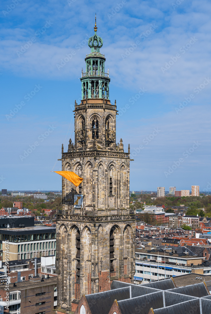 The famous Martinitoren in Groningen with orange and Dutch flags during Kingsday.