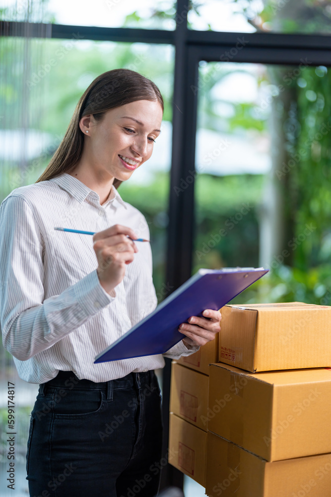 Startup, delivery and shipping in boxes for online shopping business. Businesswoman packing products from online business in a box to ship to clients and buyers.business woman working in the office Startup, delivery and shipping in boxes for online shopping business. Businesswoman packing products from online business in a box to ship to clients and buyers.business woman working in the office