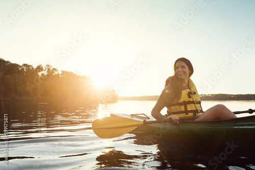 When life gets complicated, go kayaking. a beautiful young woman kayaking on a lake outdoors.