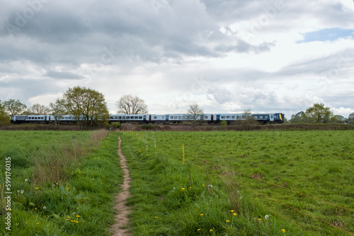 SWR train travelling through the countryside on a stormy spring day