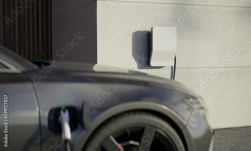 Close up of modern generic electric vehicle EV hybrid car is being charged from a wallbox near a contemporary modern residential building house photo