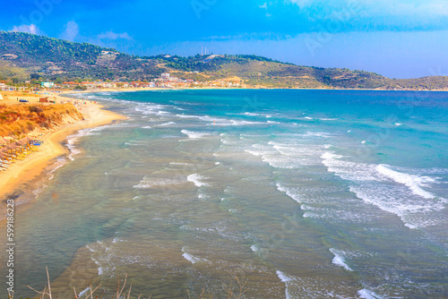 Sarti, Greece summer greek beach vacation panorama with turquoise sea water waves and umbrellas photo