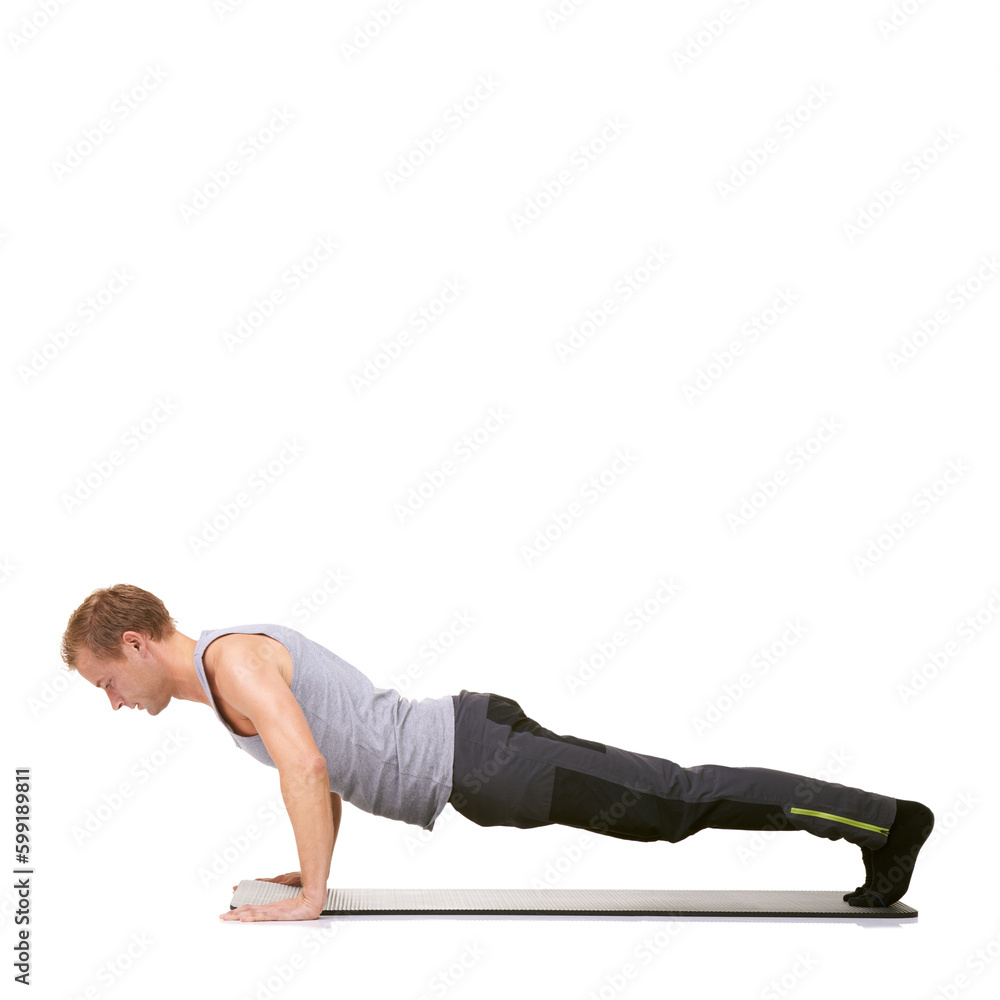 Strength and determination - Fitness. A fit young man doing push-ups on his exercise mat while isolated on white. Strength and determination - Fitness. A fit young man doing push-ups on his exercise mat while isolated on white.