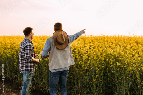 Two farmers standing on their farmland. © cherryandbees