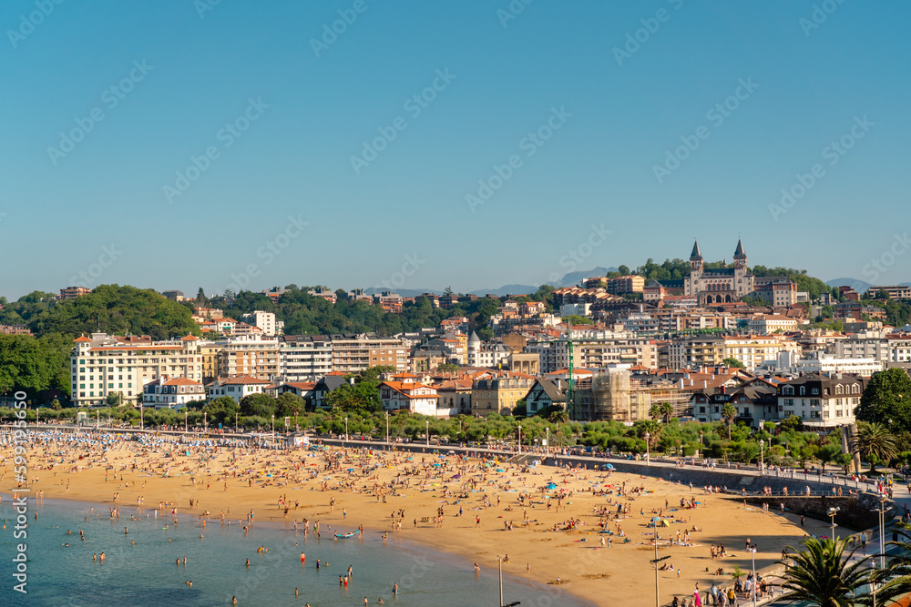 San Sebastian, SPAIN - July 09 2022: High angle view of San Sebastian - Donostia City. Situated in north of Spain in Vesque Country. View of city center and part of Ondarreta Beach. Warm sunset colour