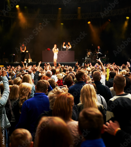 Dance, music and stage with crowd at festival for concert, dj show and rave performance. Rock, energy and hands of people dancing in audience for party celebration, disco and techno event