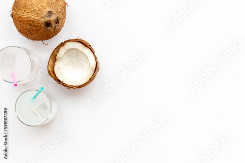 Coconut fresh milk cocktail in glasses with half of coconut
