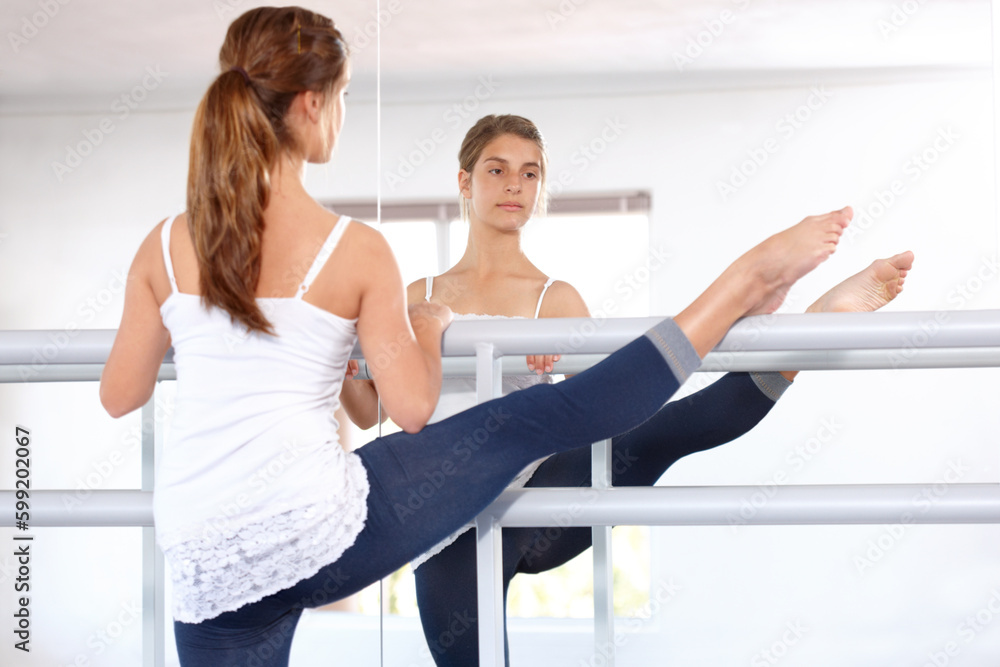 Ballet takes dedication. A young ballerina putting in the hours in her dance studio. Ballet takes dedication. A young ballerina putting in the hours in her dance studio.