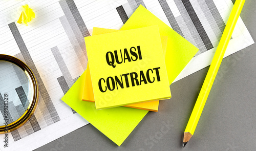 Quasi Contract text on sticky on sticky on chart with pen photo