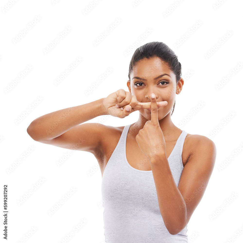 Keeping silent. A young woman in gym clothes with her fingers crossed and pressed against her mouth. Keeping silent. A young woman in gym clothes with her fingers crossed and pressed against her mouth.