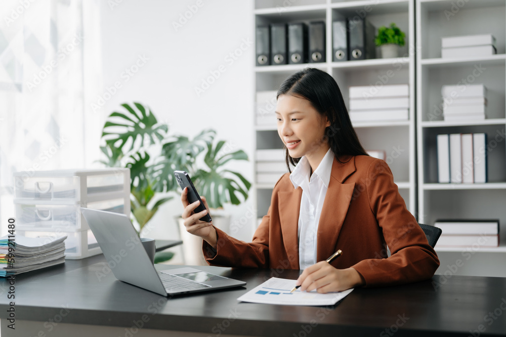 Business woman using tablet and laptop for doing math finance on an office desk, tax, report, accounting, statistics, and analytical research concept in office Business woman using tablet and laptop for doing math finance on an office desk, tax, report, accounting, statistics, and analytical research concept in office