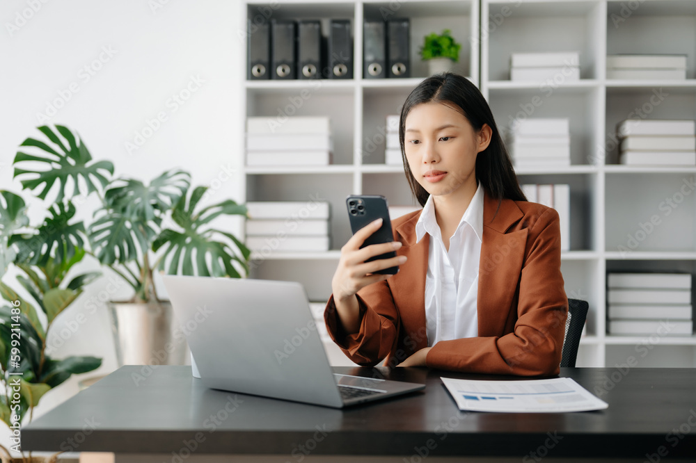 Business woman using tablet and laptop for doing math finance on an office desk, tax, report, accounting, statistics, and analytical research concept in office Business woman using tablet and laptop for doing math finance on an office desk, tax, report, accounting, statistics, and analytical research concept in office