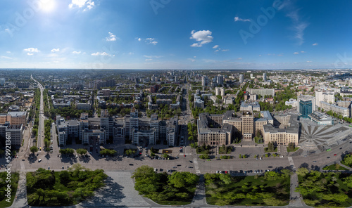 Aerial view on Derzhprom, northern Karazin National University and hotel buildings on Freedom Square, spring greenery and blue sky in Kharkiv, Ukraine