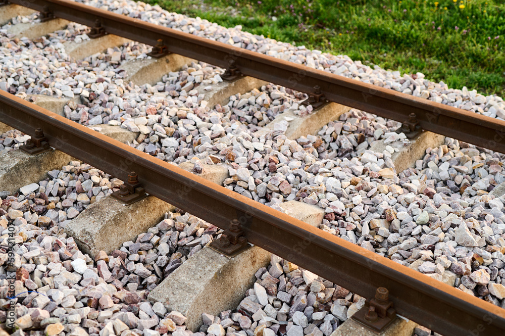 Naklejka premium New railway rails on sleepers at a freight railway station