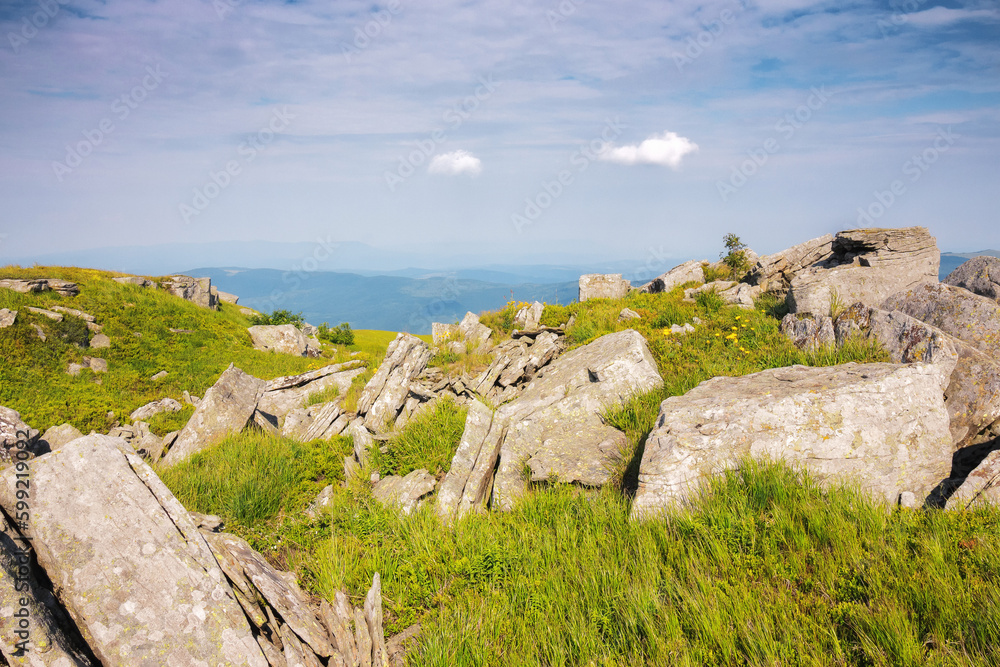 mountainous countryside in summer. boulders and rock formations among the grassy hills. sunny forenoon mountainous countryside in summer. boulders and rock formations among the grassy hills. sunny forenoon