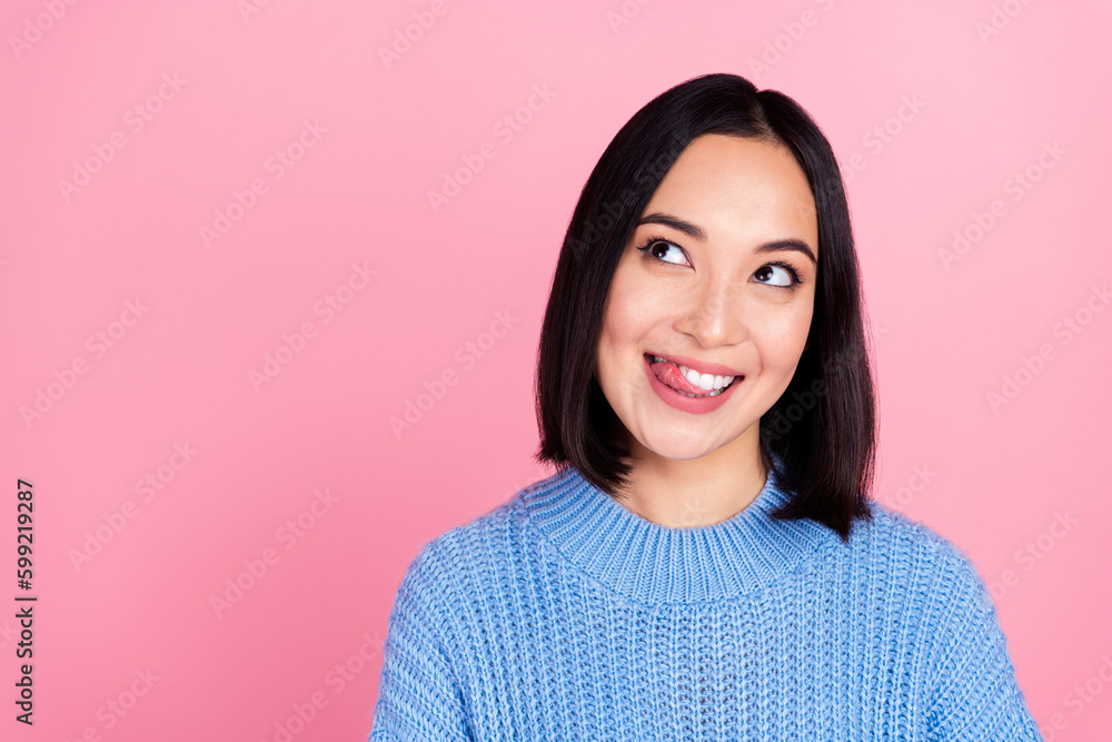 Portrait of cheerful pretty person tongue lick teeth look interested empty space isolated on pink color background Portrait of cheerful pretty person tongue lick teeth look interested empty space isolated on pink color background