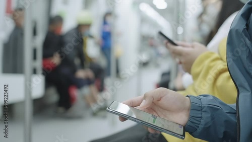 City subway passengers looking at mobile phones