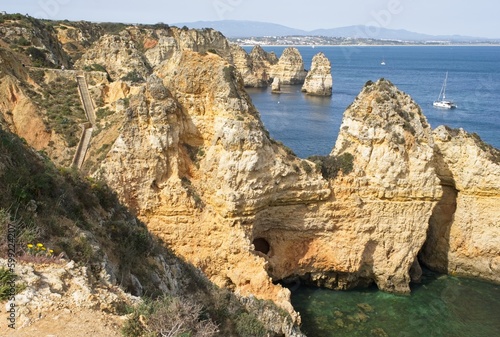 Lagos, Portugal - April 10, 2023: Wonderful landscapes in Portugal. Scenic and coloured view of Ponta da Piedade in the Algarve region. Yellow rocky skerries. Sunny spring day. Selective focus