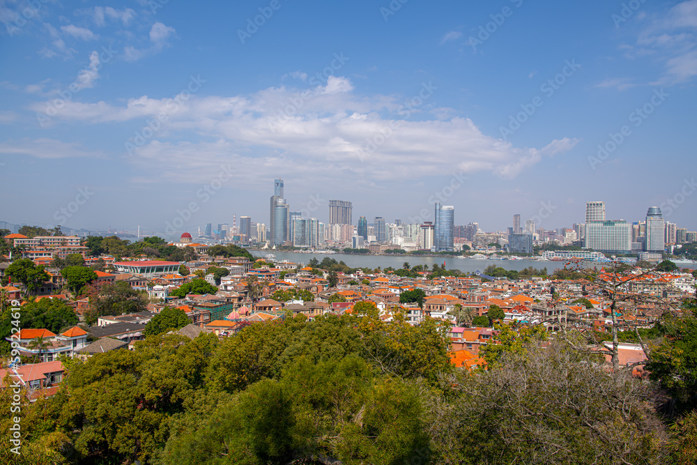 Gulangyu, China - February, 2021: Aerial view of Gulangyu island with Xiamen skyline. Blue sky with copy space for text