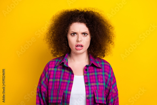 Closeup portrait of funny aggressive woman confused bad news chevelure hairstyle open mouth unexpected reaction isolated on yellow color background