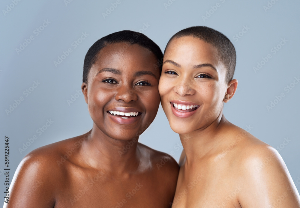 Its all smiles when were together. Portrait of two beautiful young women standing close to each other against a grey background. Its all smiles when were together. Portrait of two beautiful young women standing close to each other against a grey background.