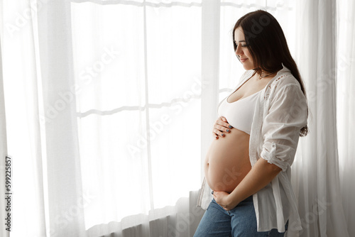 Pregnant woman standing near window in appartment strokes hugging the belly tummy abdomen enjoying pregnancy. Future family, baby infant expecting child inside
Free Download Pregnant woman standing near window in appartment strokes hugging the belly tummy abdomen enjoying pregnancy. Future family, baby infant expecting child inside
- GFXLoad