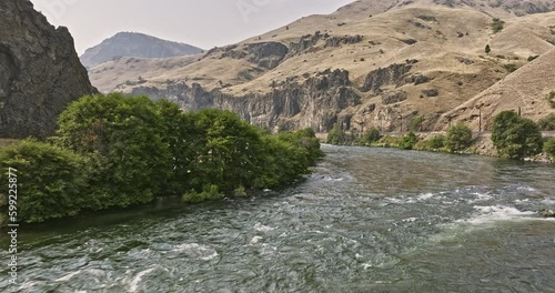 Deschutes River Oregon Aerial v85 cinematic drone flyover Deschutes river rapids along the bend capturing spectacular canyon landscape with rocky cliff wall - Shot with Mavic 3 Cine - August 2022 photo