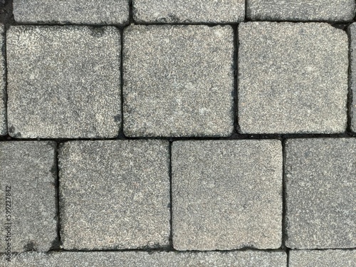 Background texture of cobblestone or paving slabs  pavement. The pavement is laid with gray stones in Bandung  and can be used for texture design and background with copy space.
