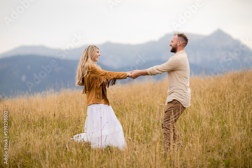 young couple seems to enjoy every moment spent together, with big smiles on their faces and hearts full of love. Dressed casually and in harmony with the beauty of the nature around them