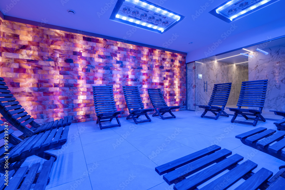 Obraz premium interior of modern wellness salt haloper cave with uv light with wooden bench