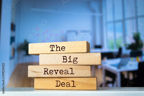 Wooden blocks with words 'The Big Reveal Deal'.