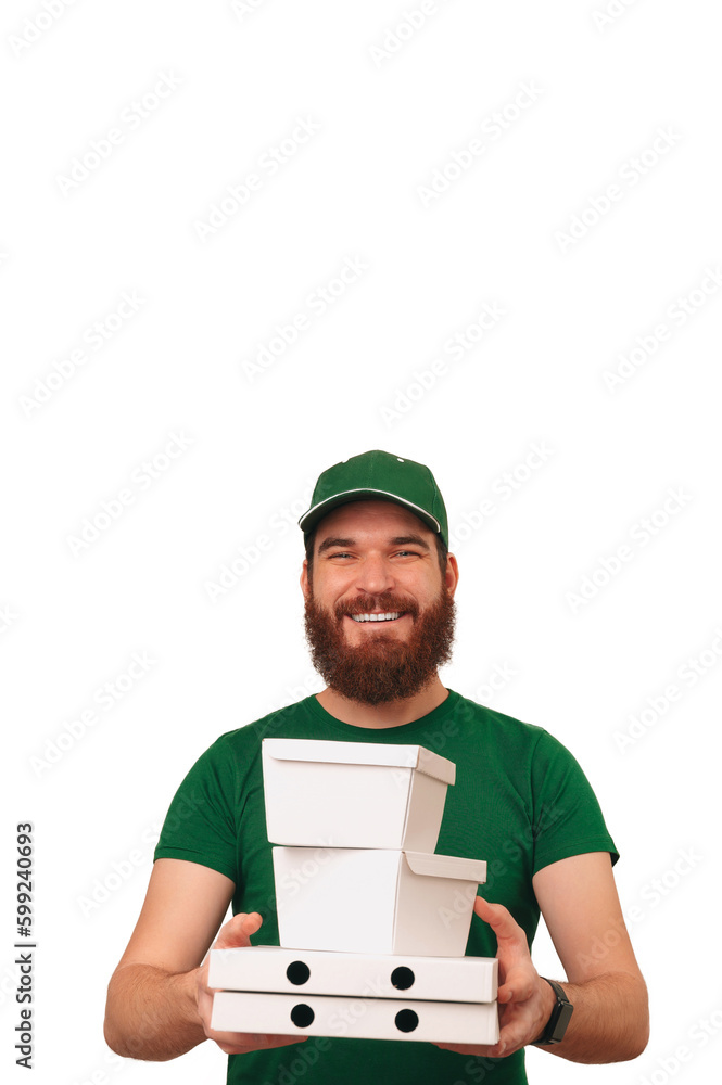 Vertical shot with white copy space of a bearded delivery man holding lunch boxes. Vertical shot with white copy space of a bearded delivery man holding lunch boxes.